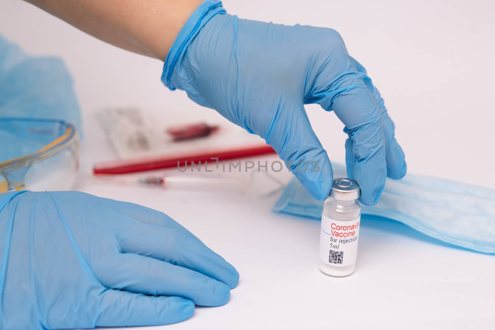 Coronavirus vaccine. Doctor with a vaccine. Hands holding a coronavirus vaccine ampoule, against Covid-19.