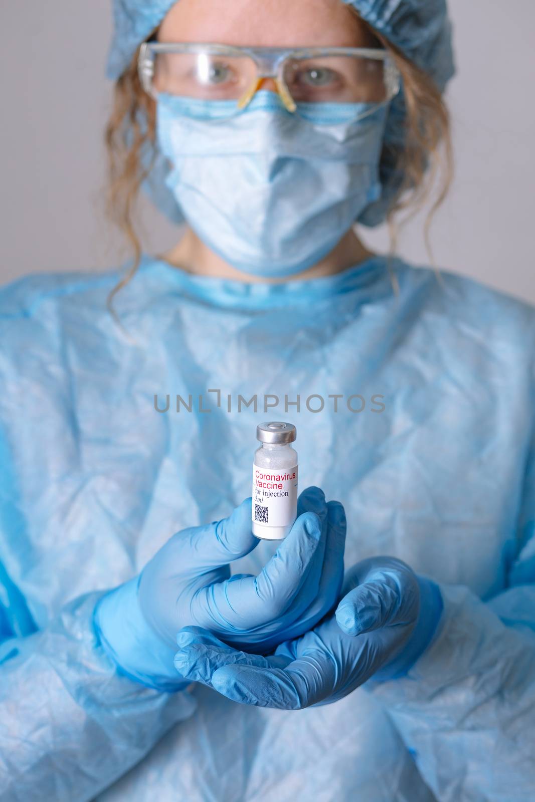 Coronavirus vaccine. Doctor with a vaccine. Nurse holding a coronavirus vaccine. Hands holding a coronavirus vaccine ampoule, against Covid-19.