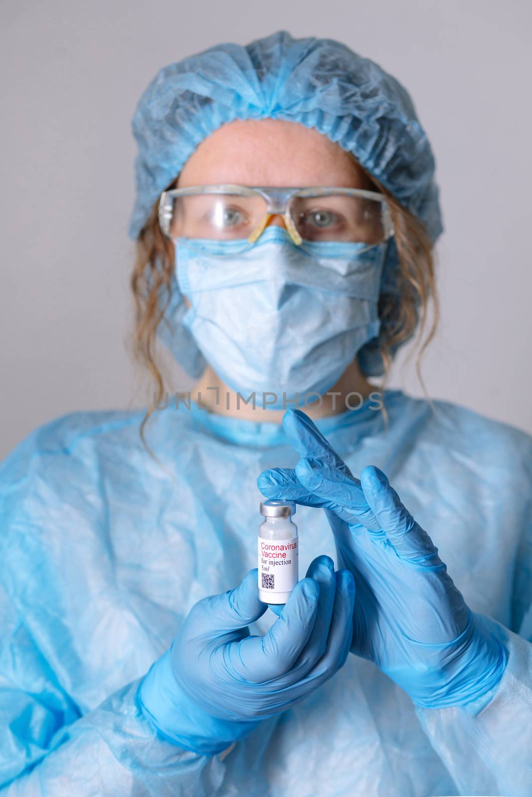 Coronavirus vaccine. Doctor with a vaccine. Nurse holding a coronavirus vaccine. Hands holding a coronavirus vaccine ampoule, against Covid-19.