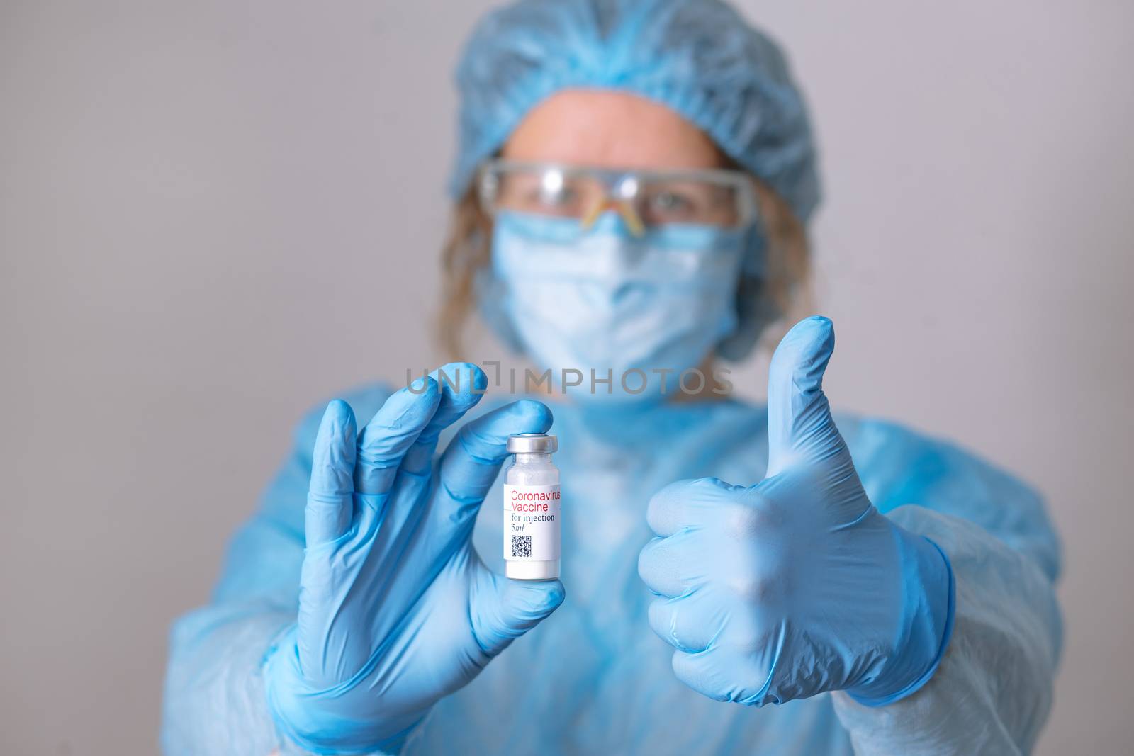 Coronavirus vaccine. Doctor with a vaccine. Nurse holding a coronavirus vaccine. Hands holding a coronavirus vaccine ampoule, against Covid-19.