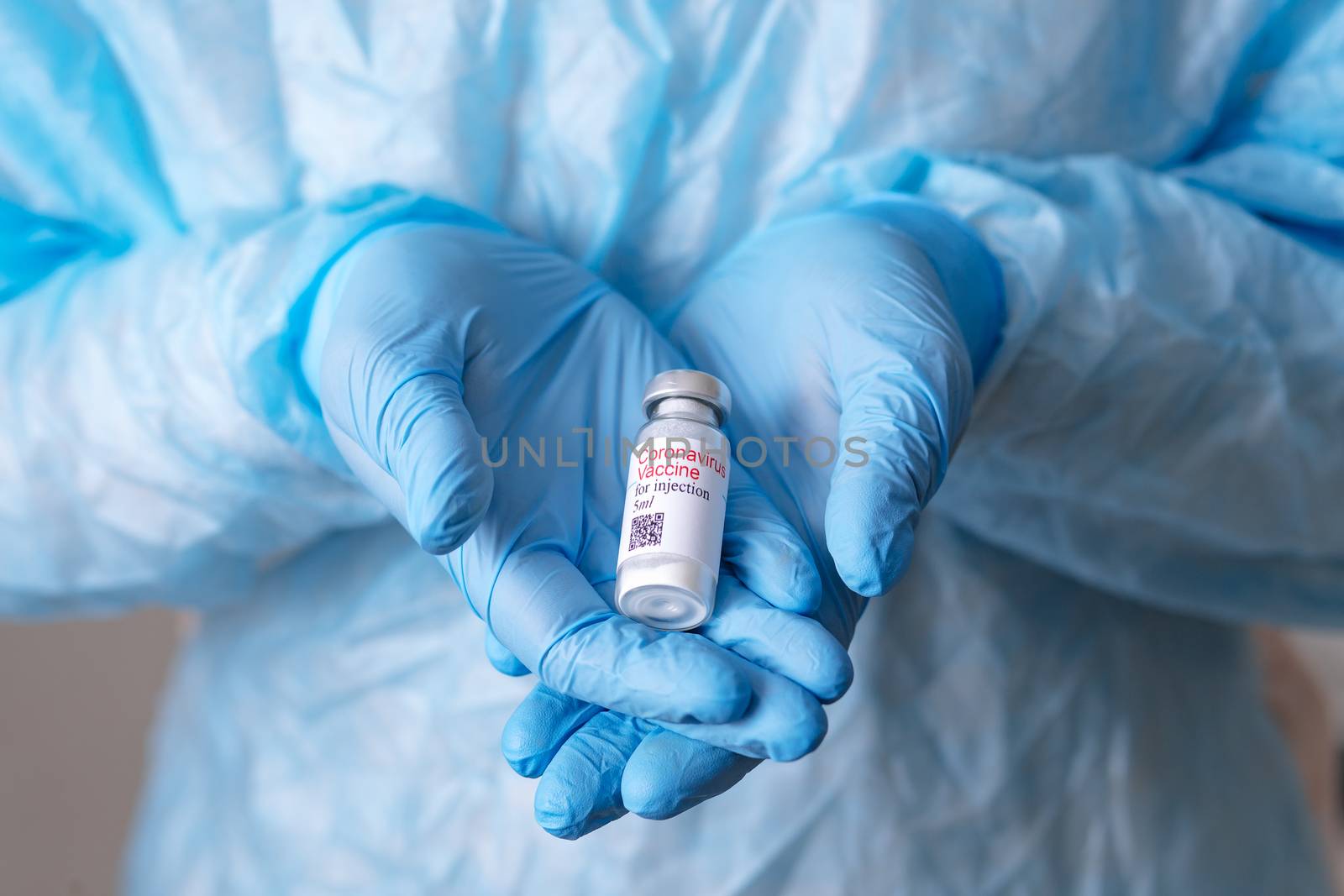 Coronavirus vaccine. Doctor with a vaccine. Nurse holding a coronavirus vaccine. Hands holding a coronavirus vaccine ampoule, against Covid-19.