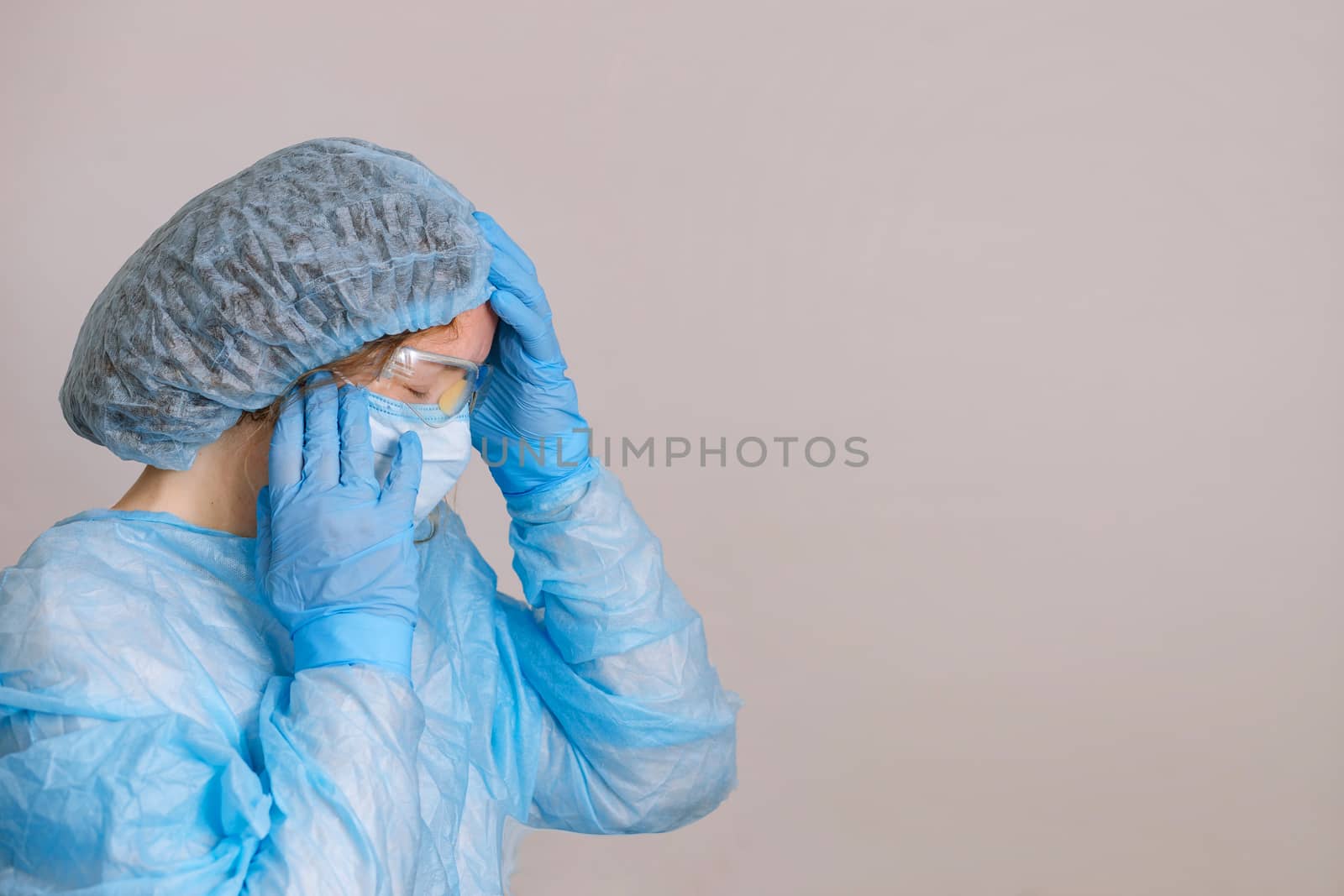 Praying tired doctor. Tired praying nurse at the hospital. The fight against the disease, viruses. A doctor, a nurse who is thinking about treating a disease and a pandemic. Surgeon after surgery.