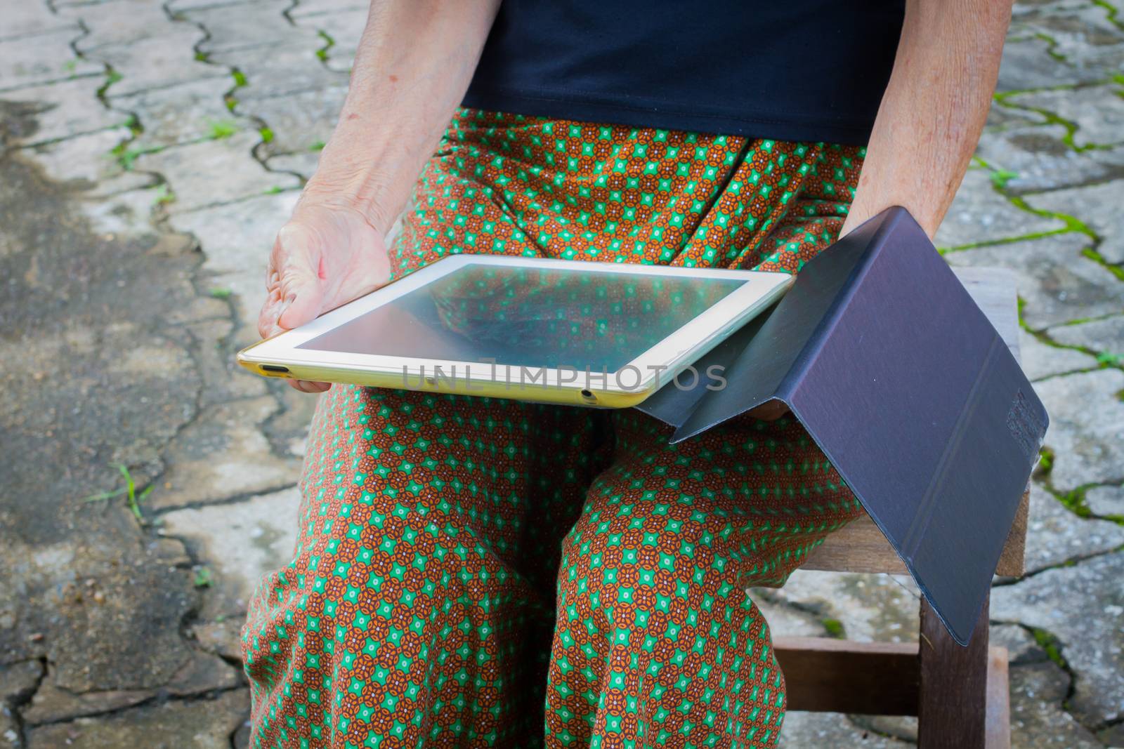 horizontal photo of closeup asian elder woman using tablet, technology concept.