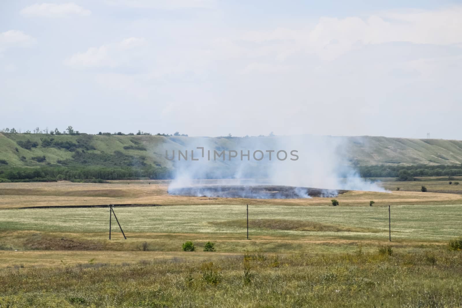 Fire in the field where hay was grown. burning dry grass