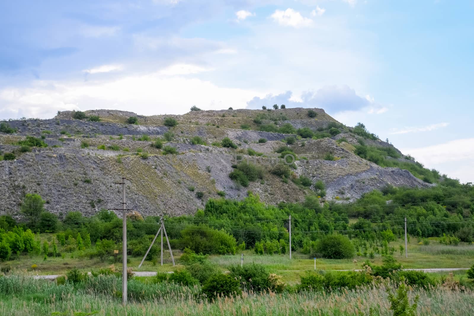ore slag dumps after processing. Old stepped terricon in the form of a hill with terraces