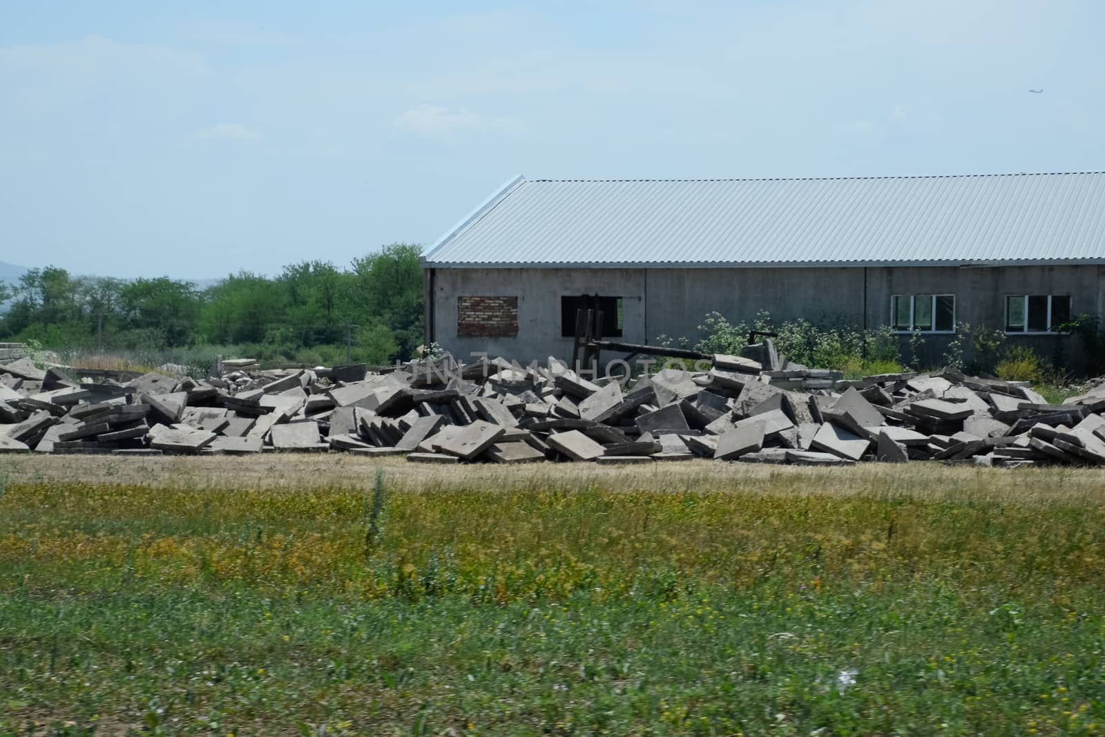 pile of concrete slabs piled up near the old building.