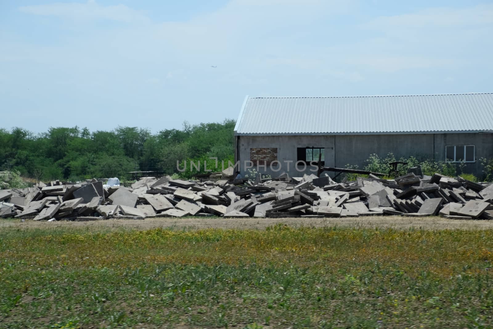 pile of concrete slabs piled up near the old building.