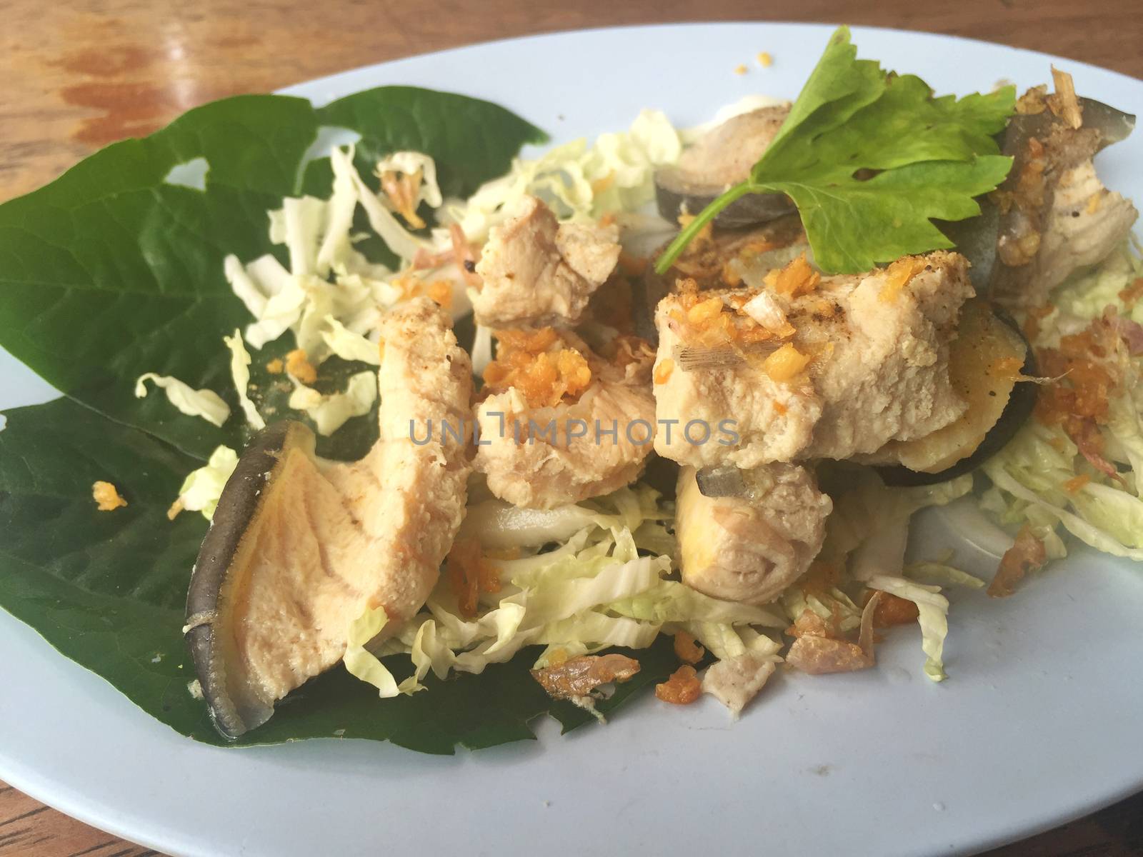horizontal photo of steamed Mekong giant catfish with vegetables 