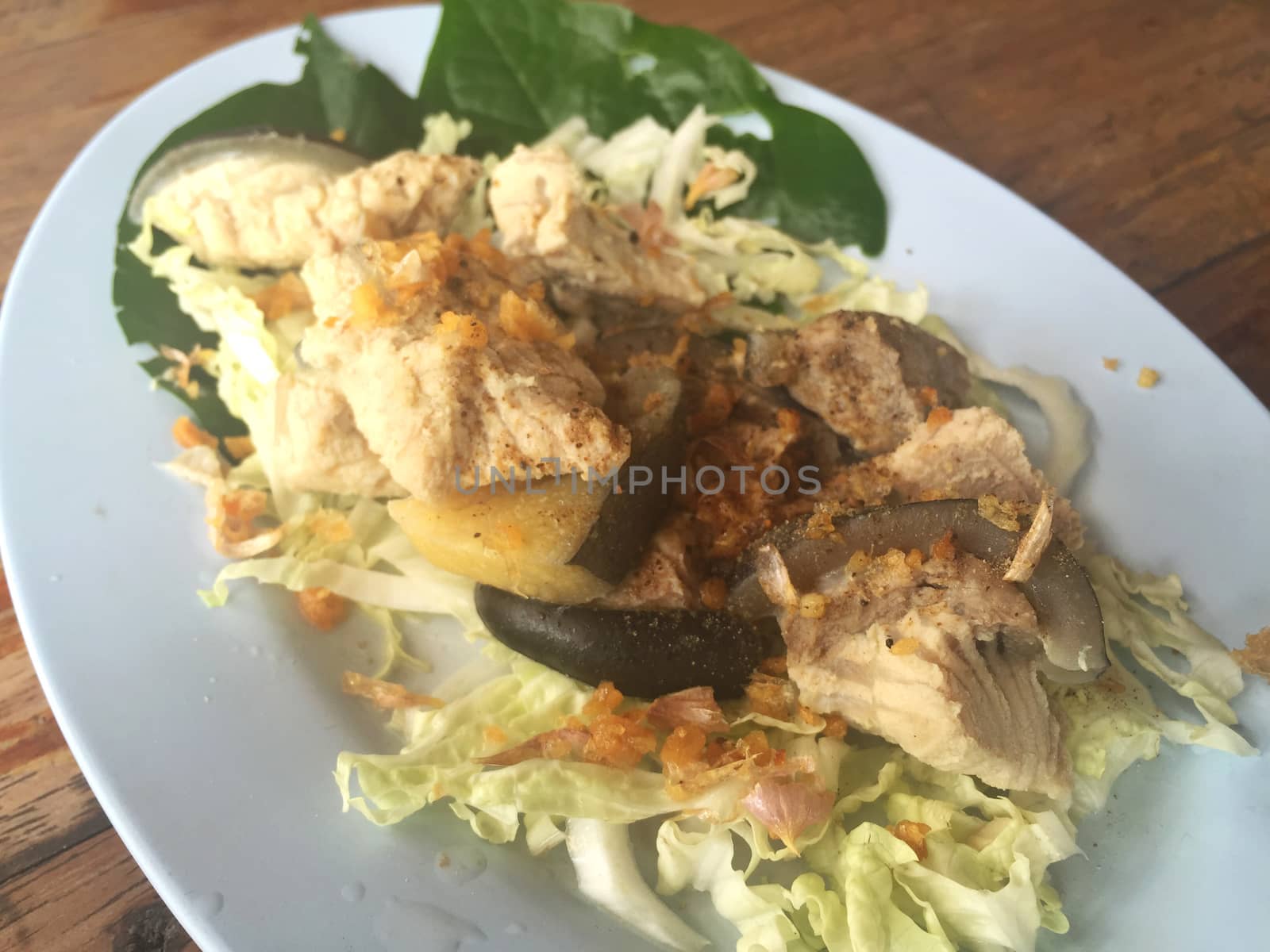 horizontal photo of steamed Mekong giant catfish with vegetables 
