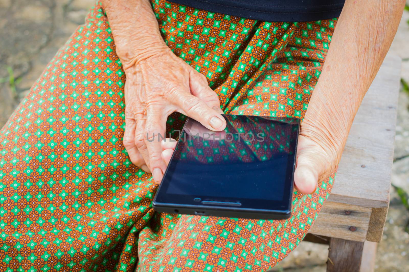 horizontal photo of closeup asian elder woman using tablet, technology concept.