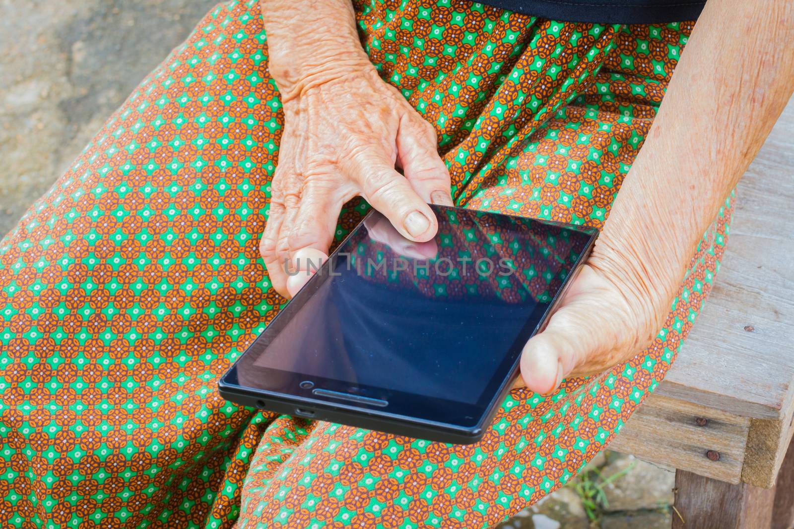 horizontal photo of closeup asian elder woman using tablet, technology concept.