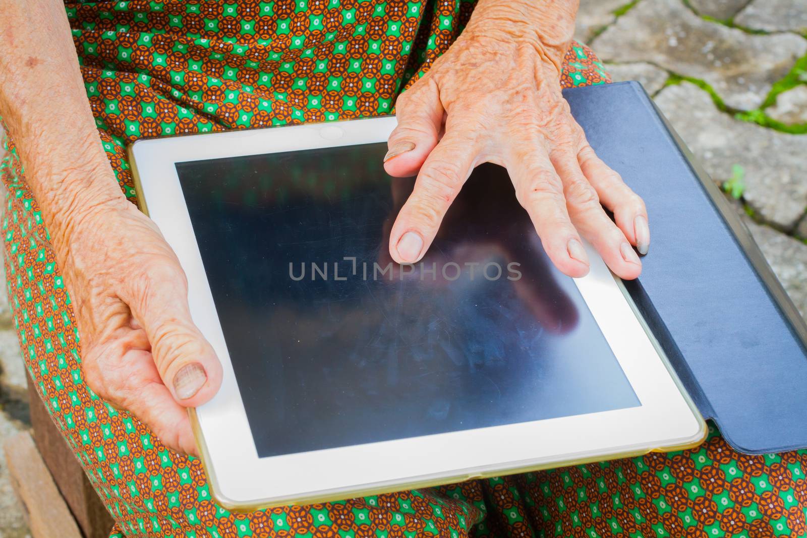 horizontal photo of closeup asian elder woman using tablet, technology concept.