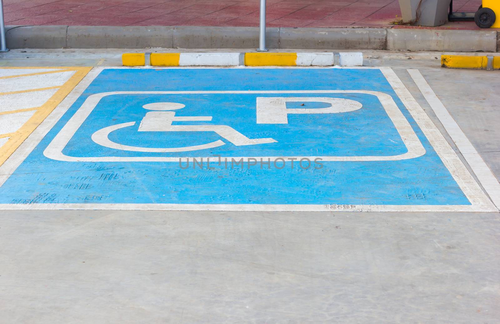 Disabled parking sign in filling station, Thailand.