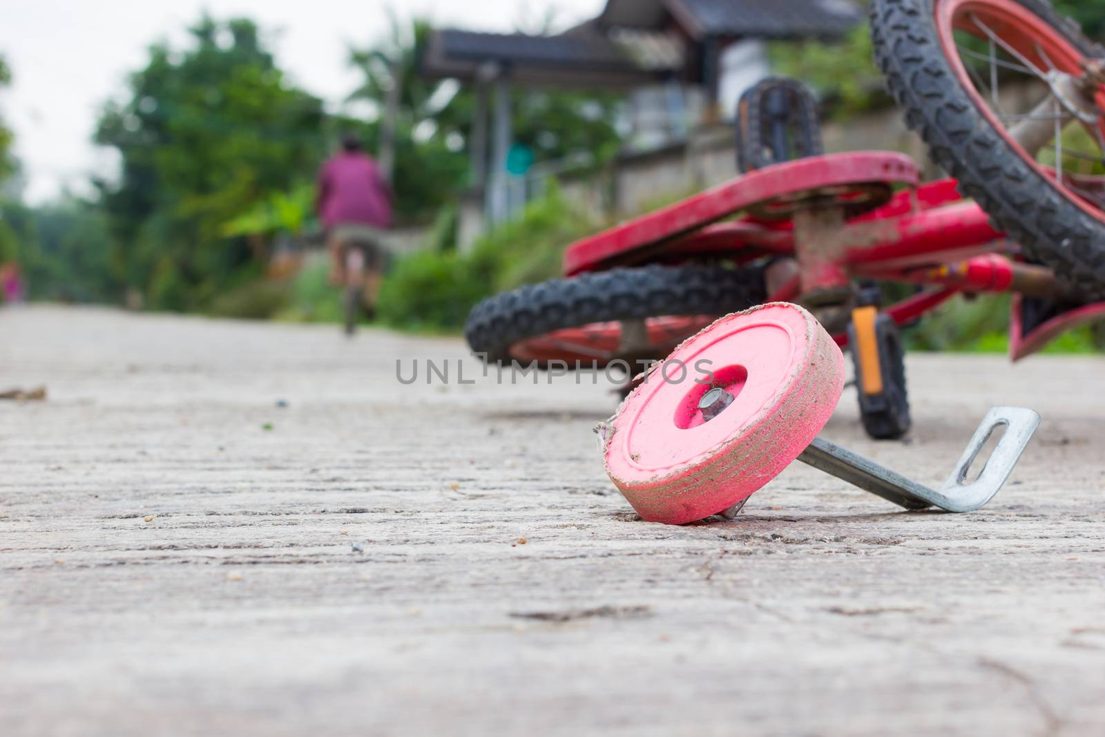 horizontal photo of closeup bicycle for children accident on the city street.