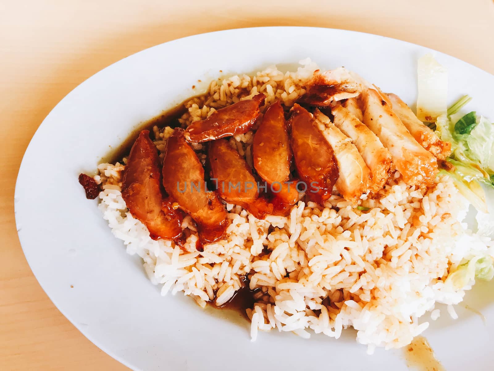 closeup roasted red pork with sweet gravy on steamed rice