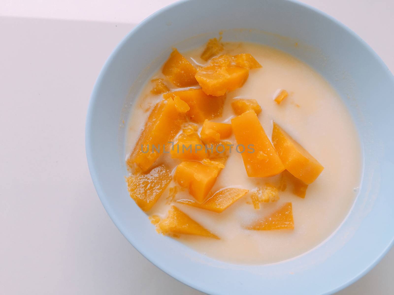 yellow pumpkin sliced in sweet coconut milk. Thai style dessert.