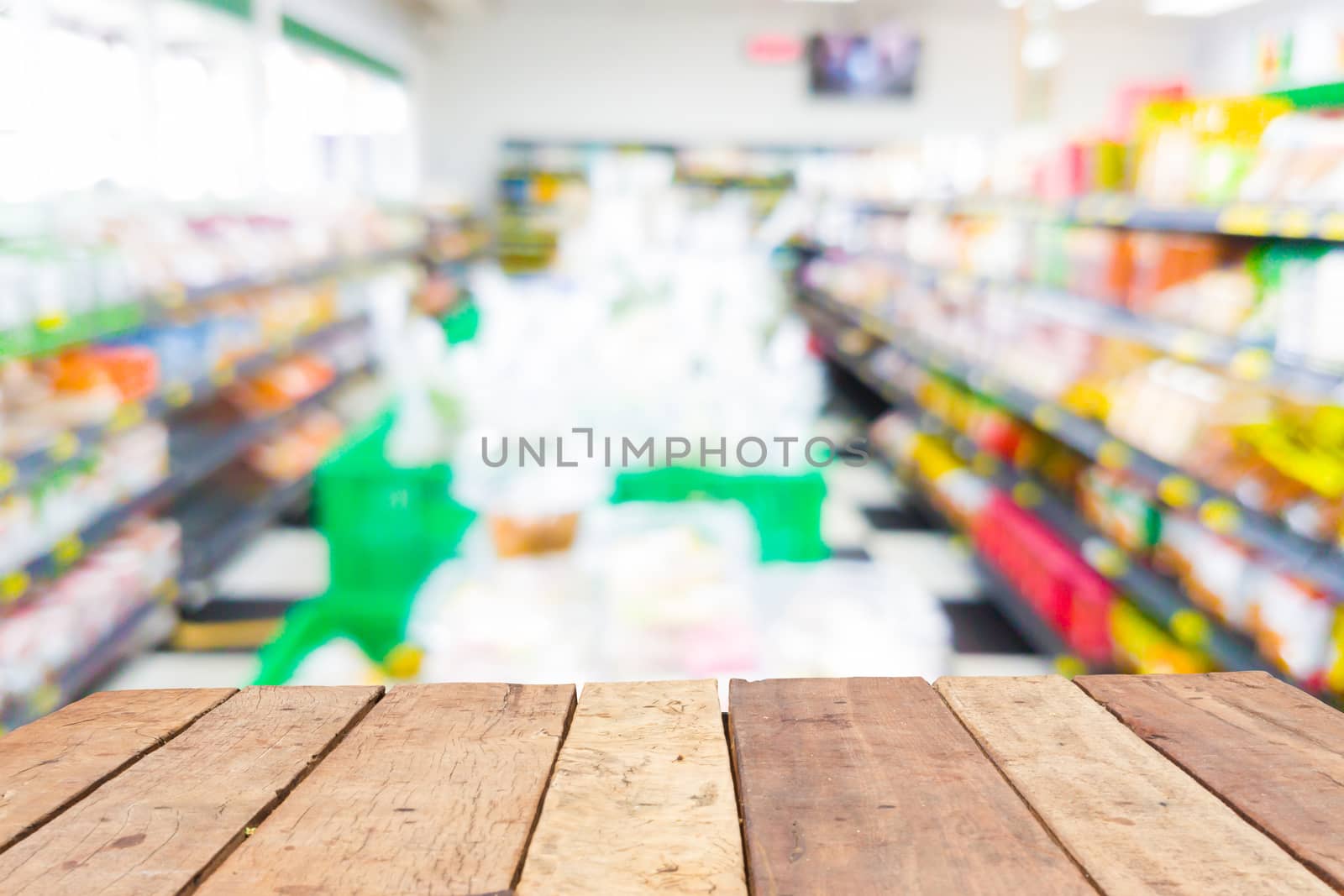 Wooden board empty table in front of blurred supermarket background 