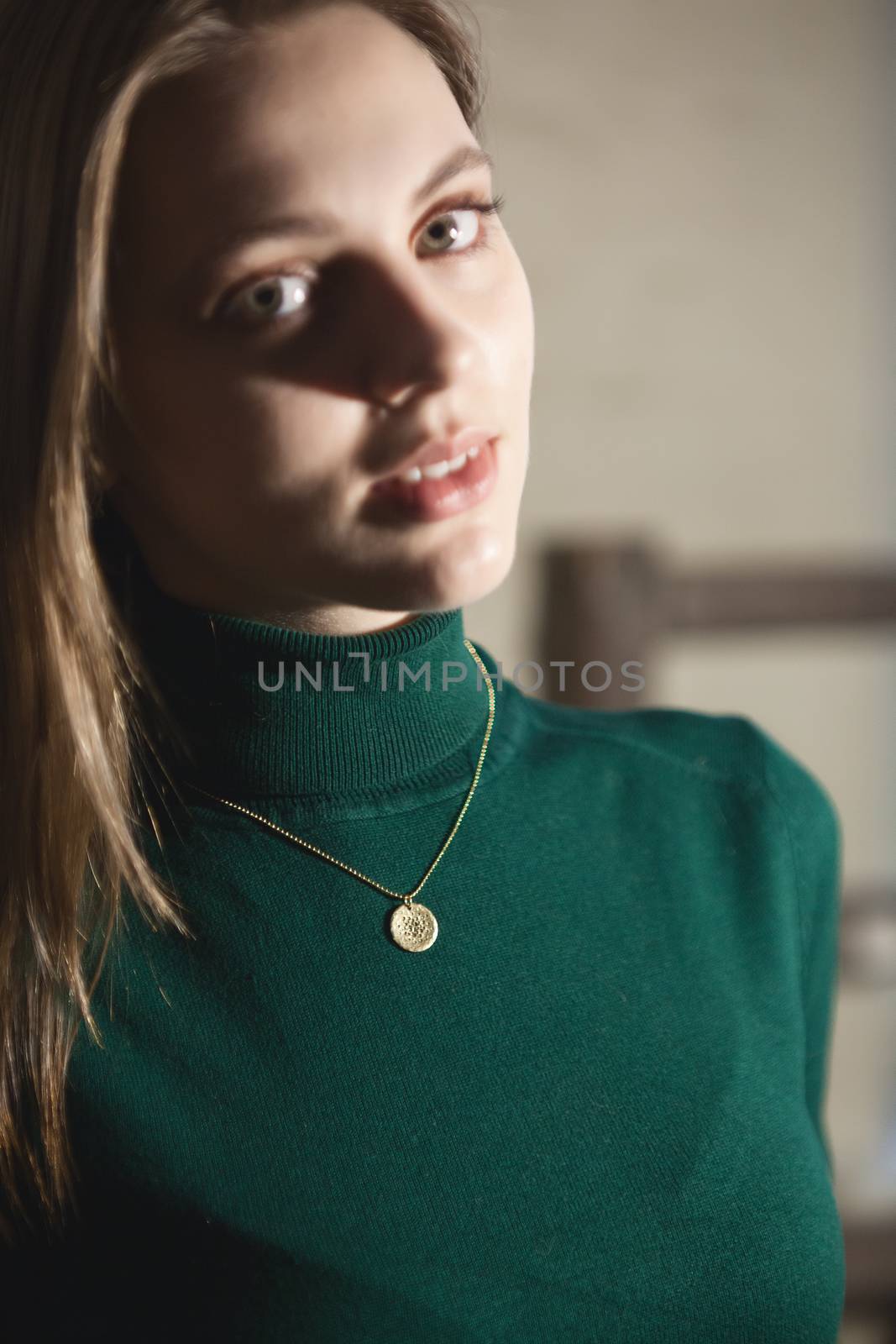 Portrait of beautiful fair young woman with fashion jewelry, one light source
