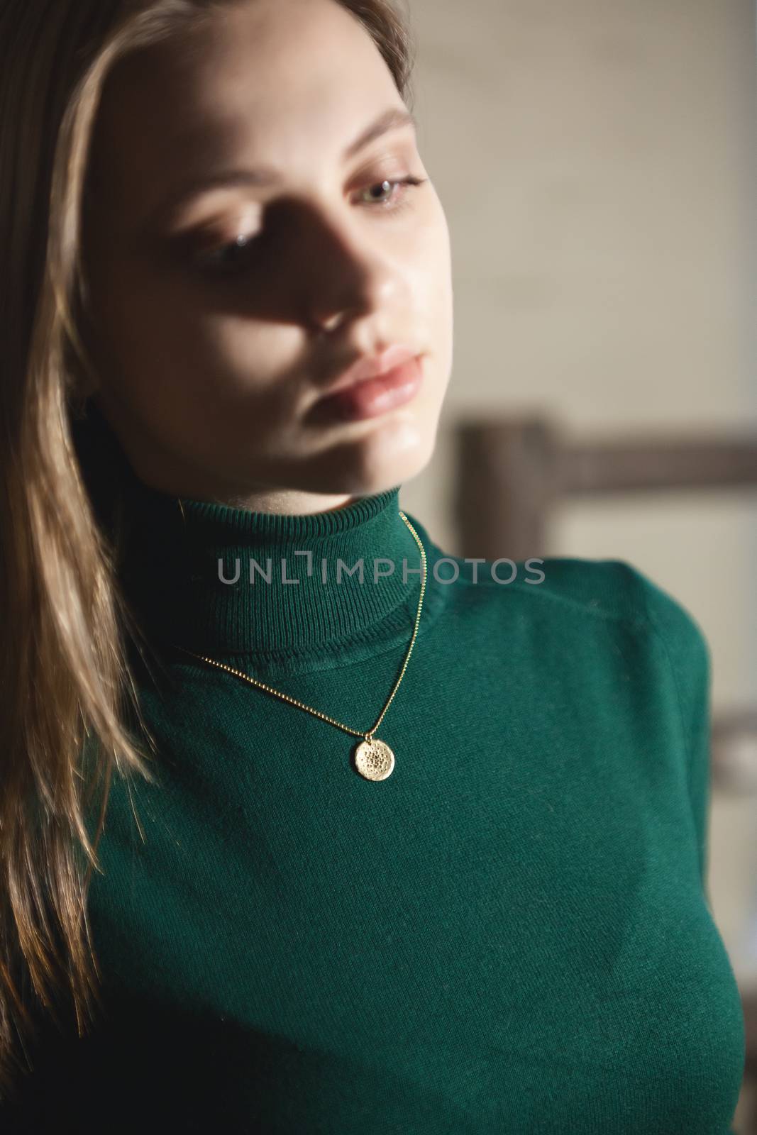 Portrait of beautiful fair young woman with fashion jewelry, one light source