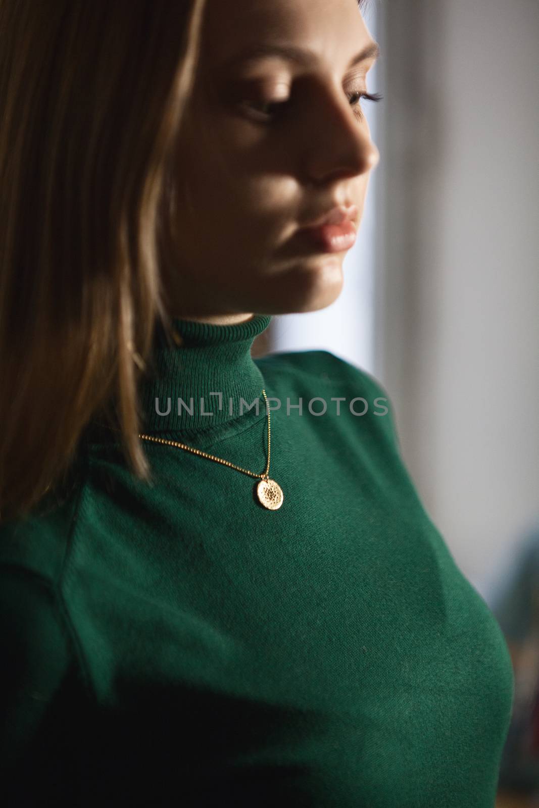 Portrait of beautiful fair young woman with fashion jewelry, one light source