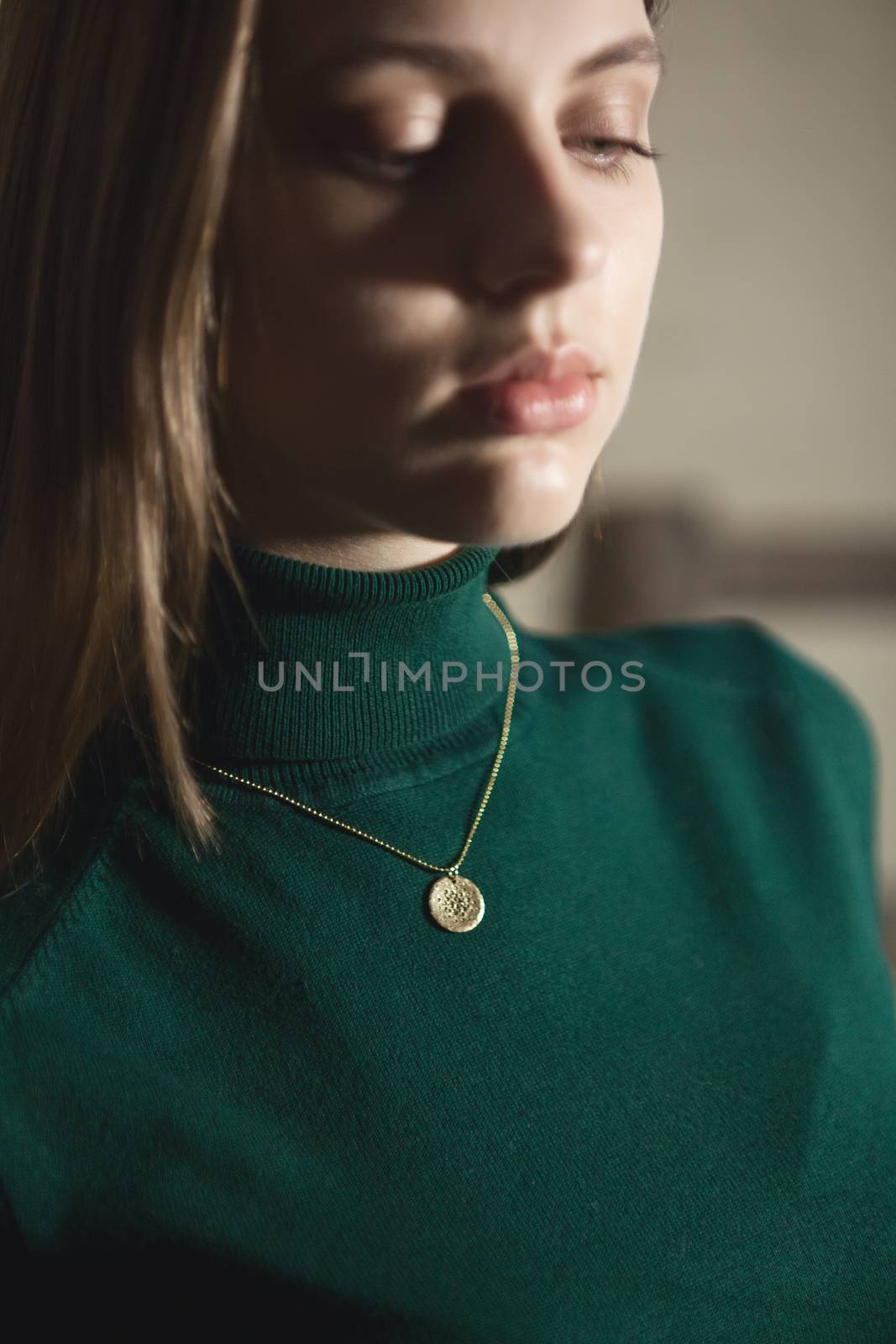 Portrait of beautiful fair young woman with fashion jewelry, one light source