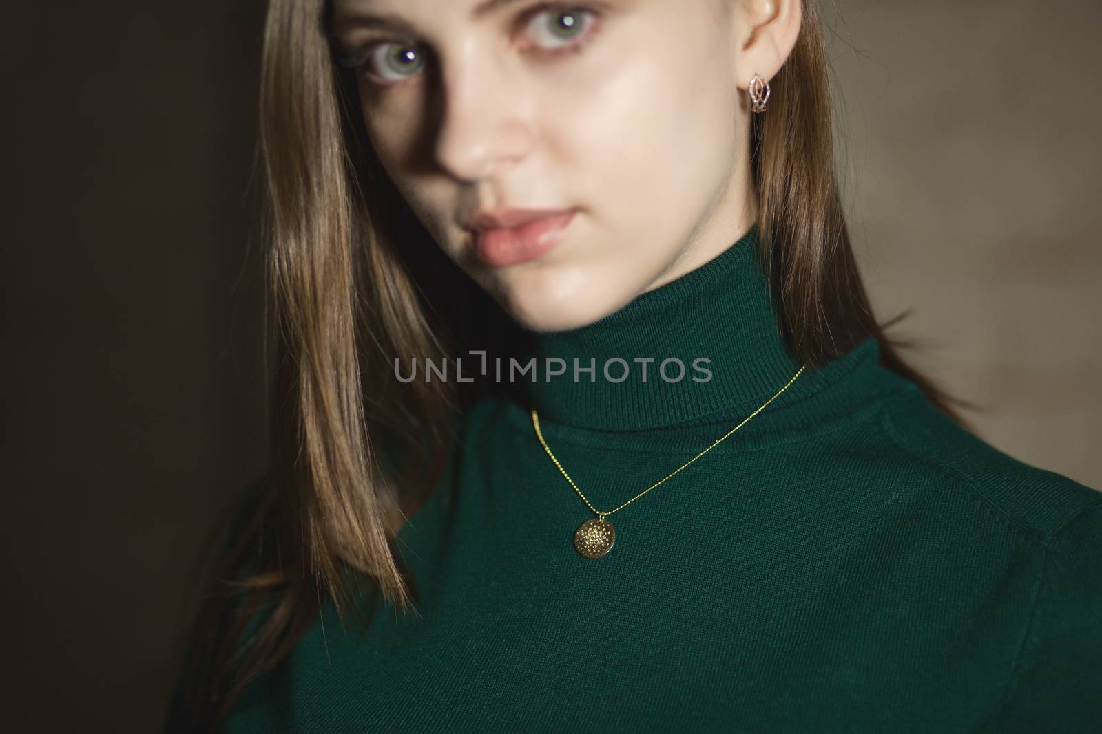 Portrait of beautiful fair young woman with fashion jewelry, one light source