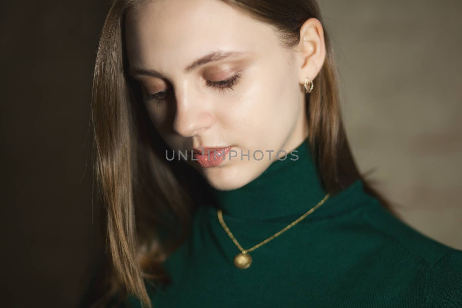 Portrait of beautiful fair young woman with fashion jewelry, one light source