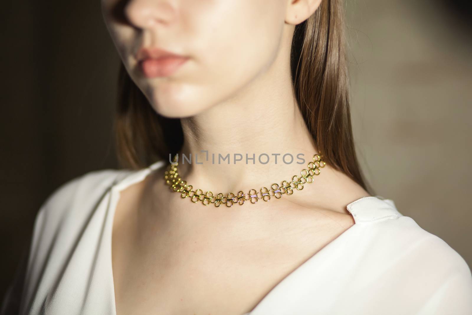 Portrait of beautiful fair young woman with fashion jewelry, one light source