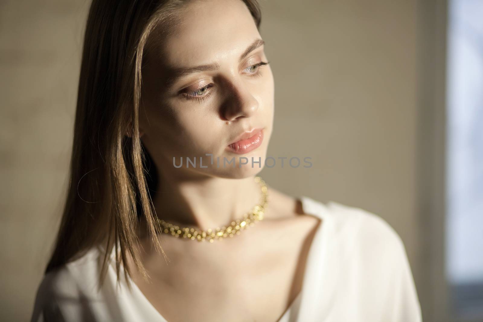 Portrait of beautiful fair young woman with fashion jewelry, one light source