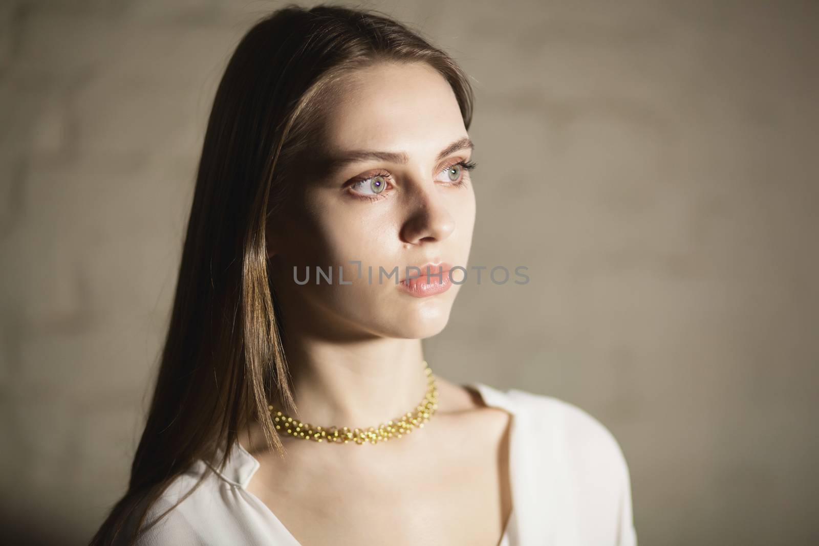 Portrait of beautiful fair young woman with fashion jewelry, one light source