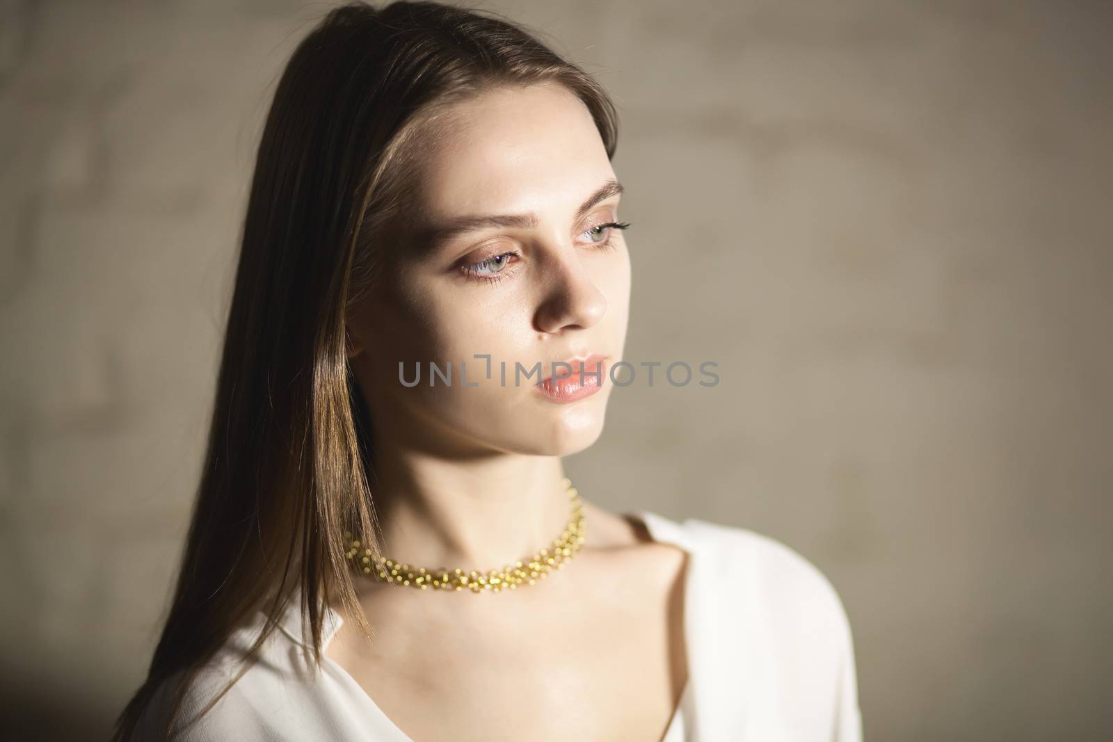 Portrait of beautiful fair young woman with fashion jewelry, one light source