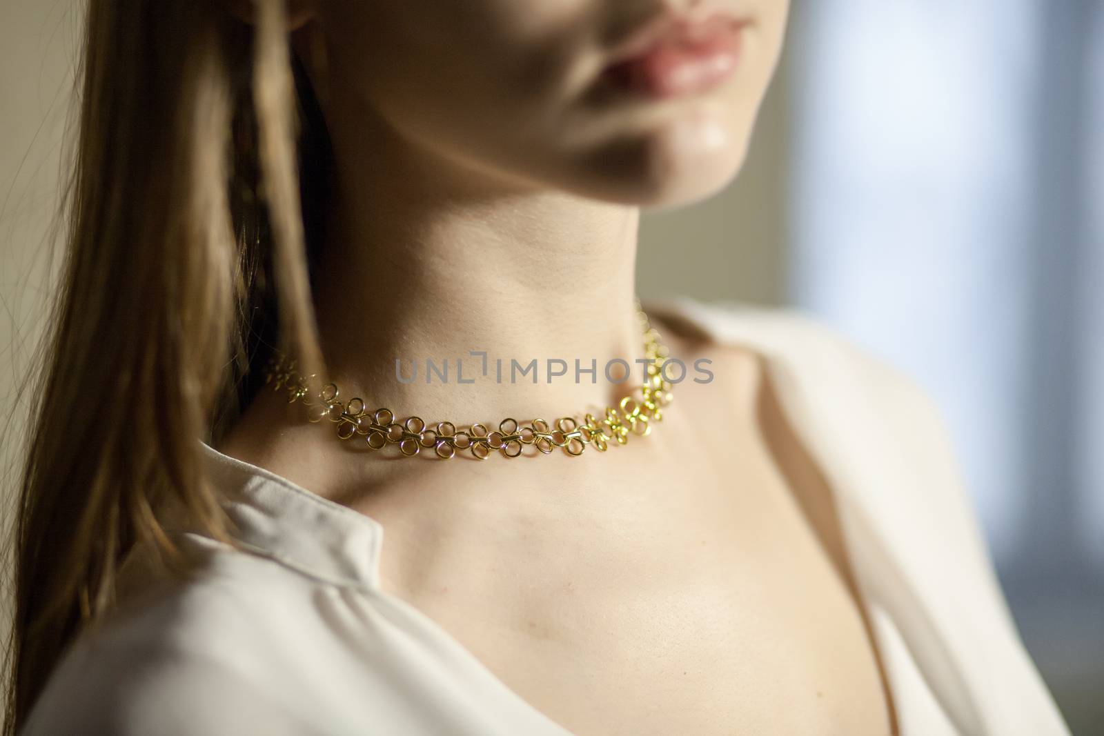 Portrait of beautiful fair young woman with fashion jewelry, one light source