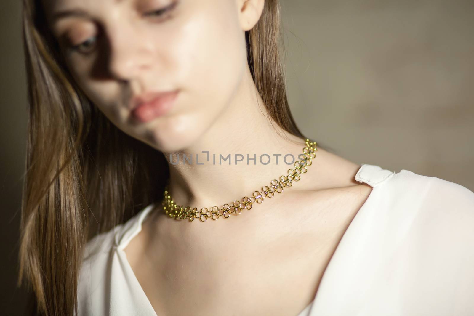 Portrait of beautiful fair young woman with fashion jewelry, one light source