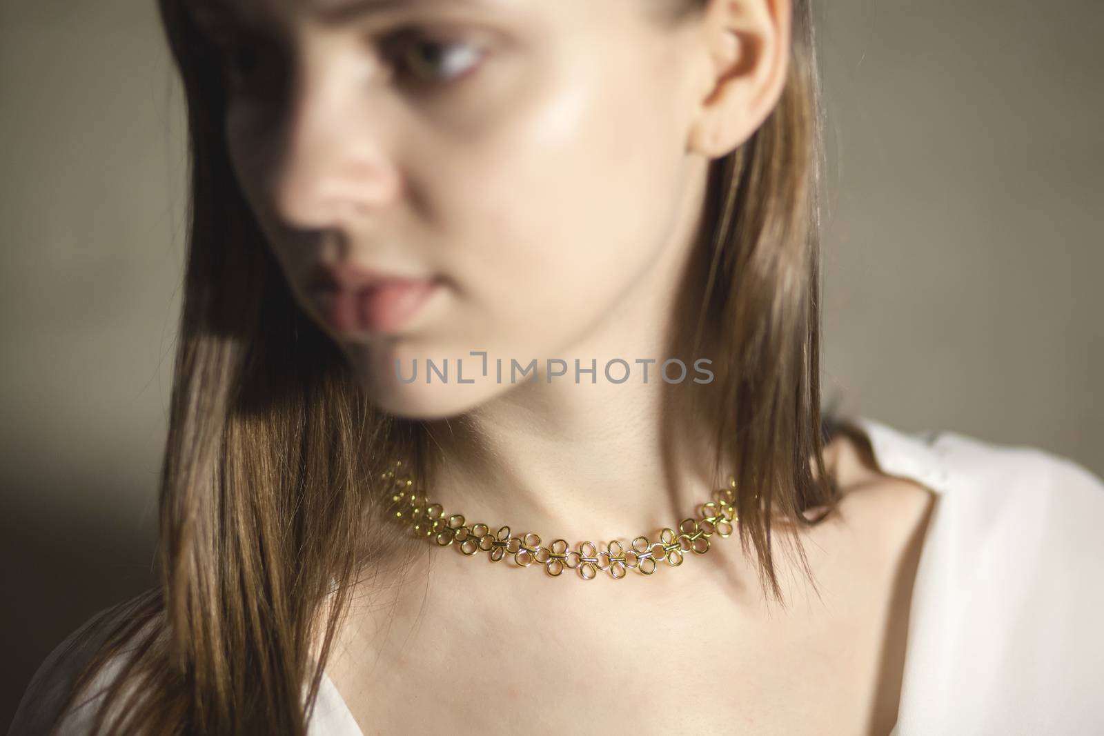 Portrait of beautiful fair young woman with fashion jewelry, one light source