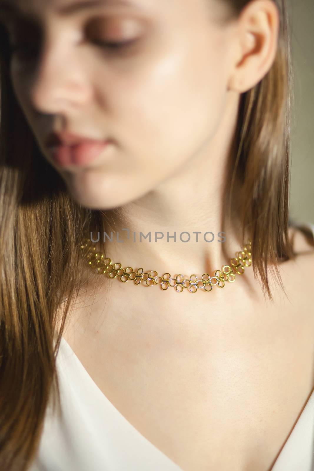 Portrait of beautiful fair young woman with fashion jewelry, one light source