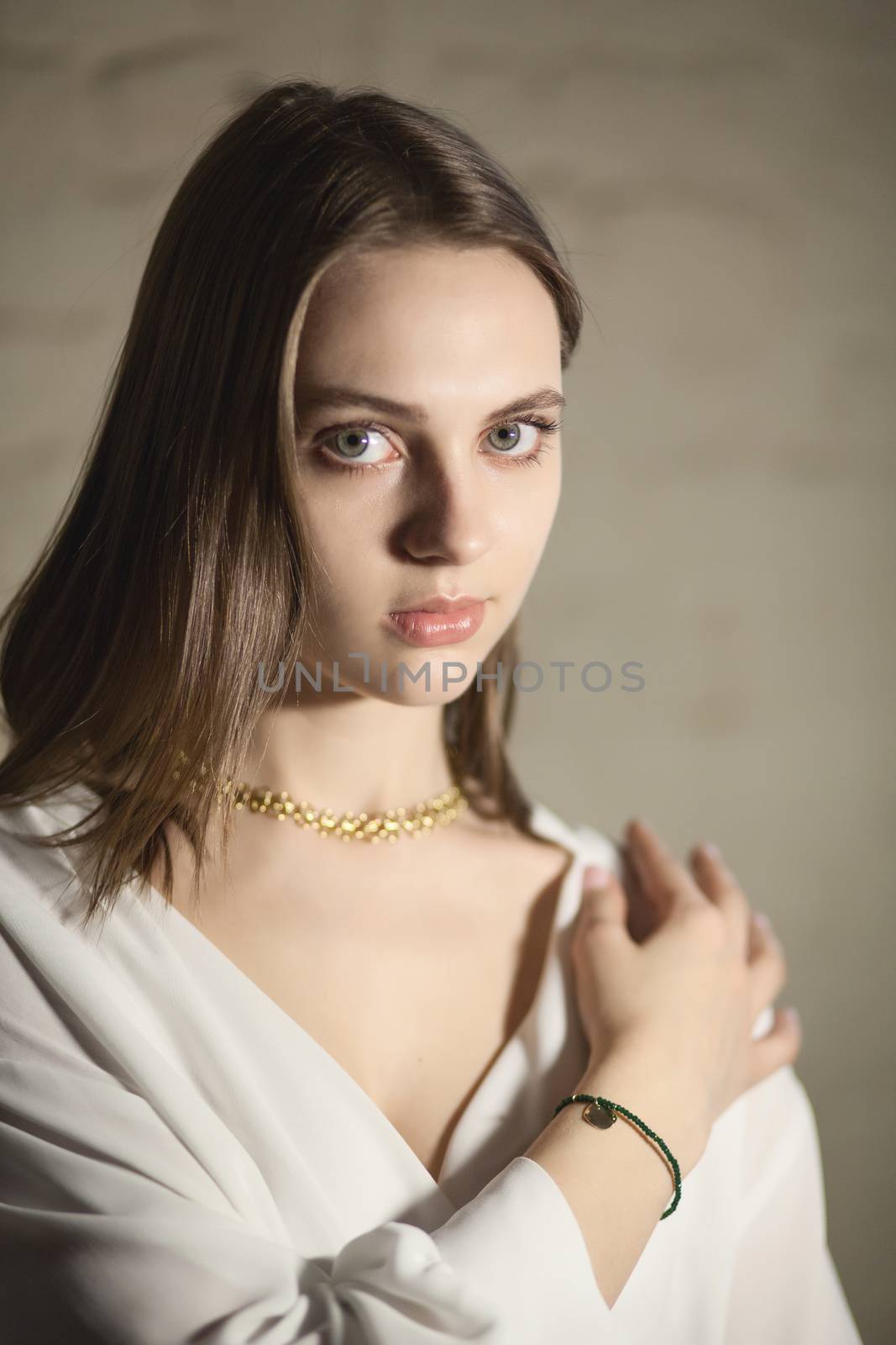 Portrait of beautiful fair young woman with fashion jewelry, one light source