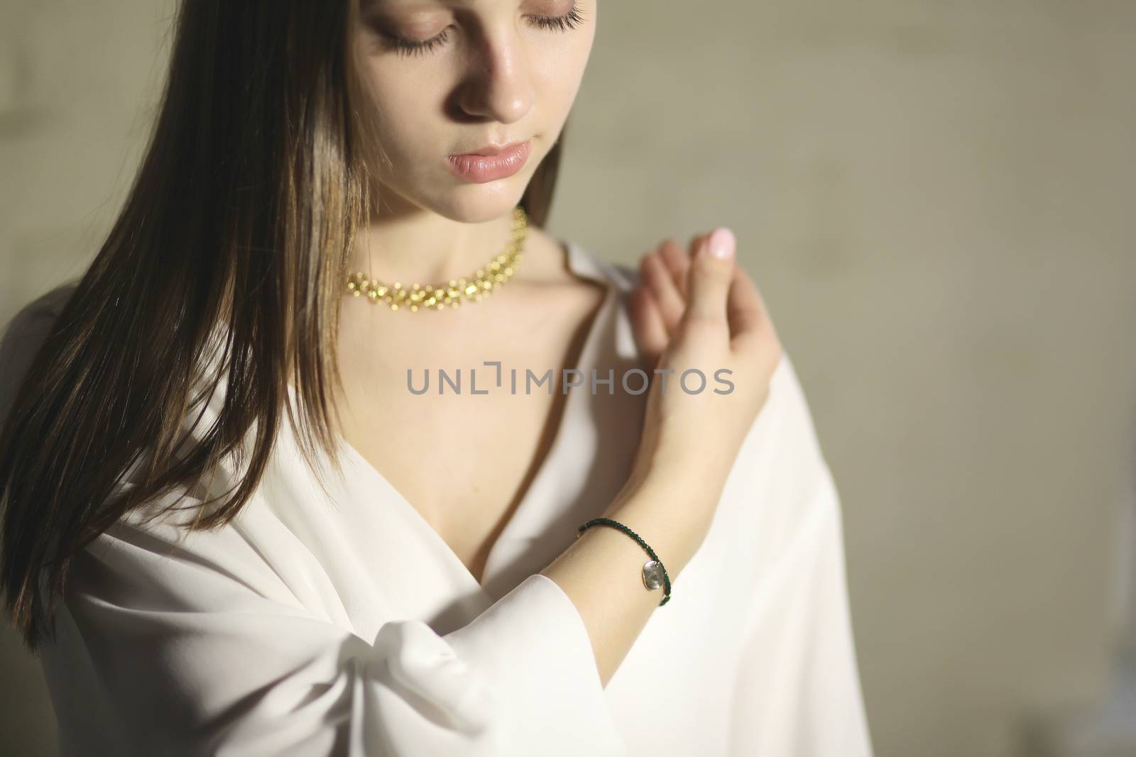 Portrait of beautiful fair young woman with fashion jewelry, one light source