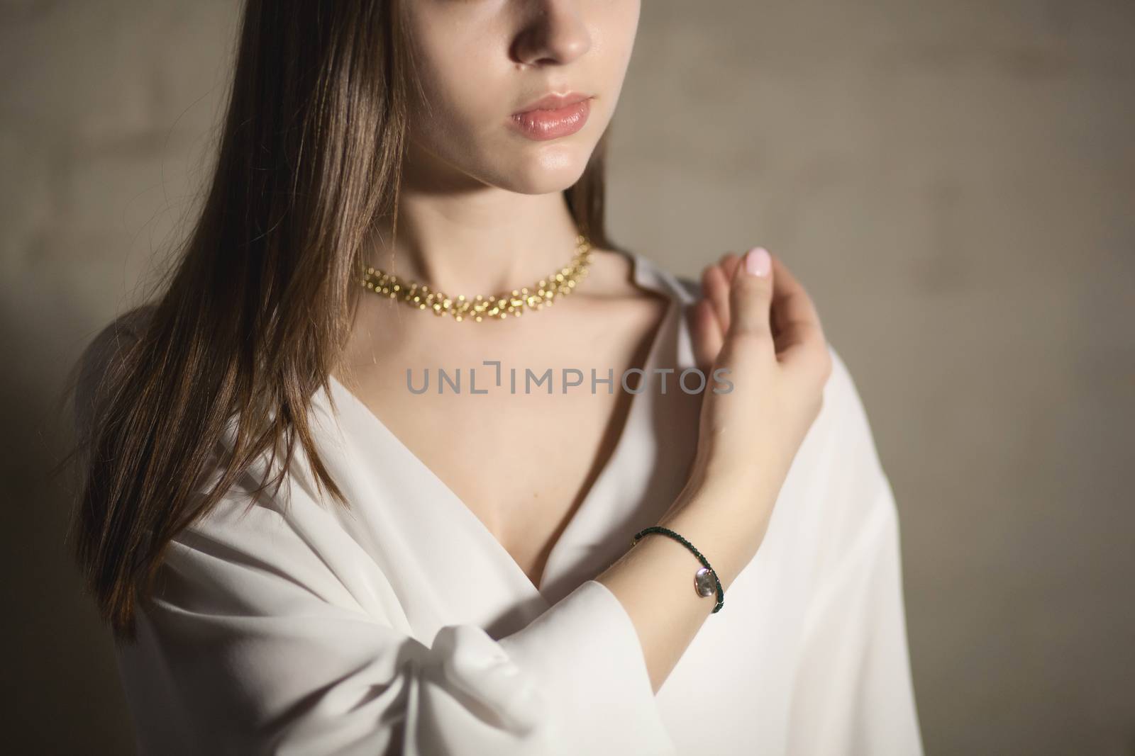 Portrait of beautiful fair young woman with fashion jewelry, one light source
