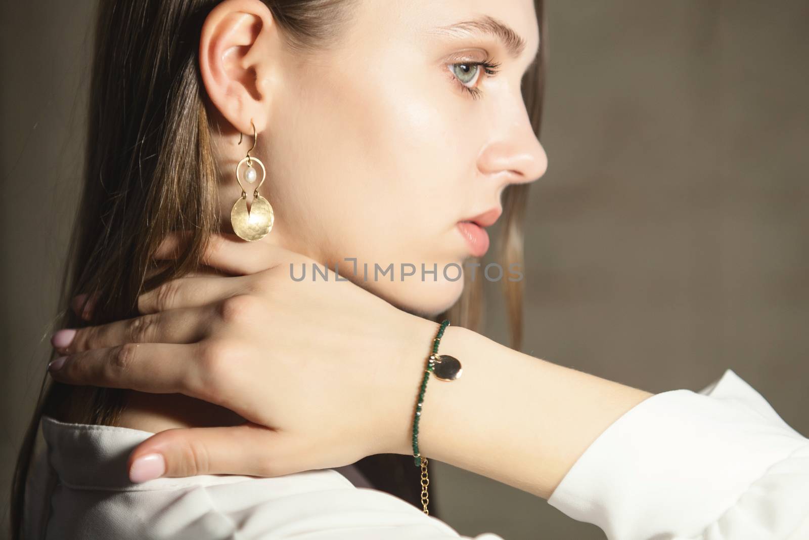 Portrait of beautiful fair young woman with fashion jewelry, one light source
