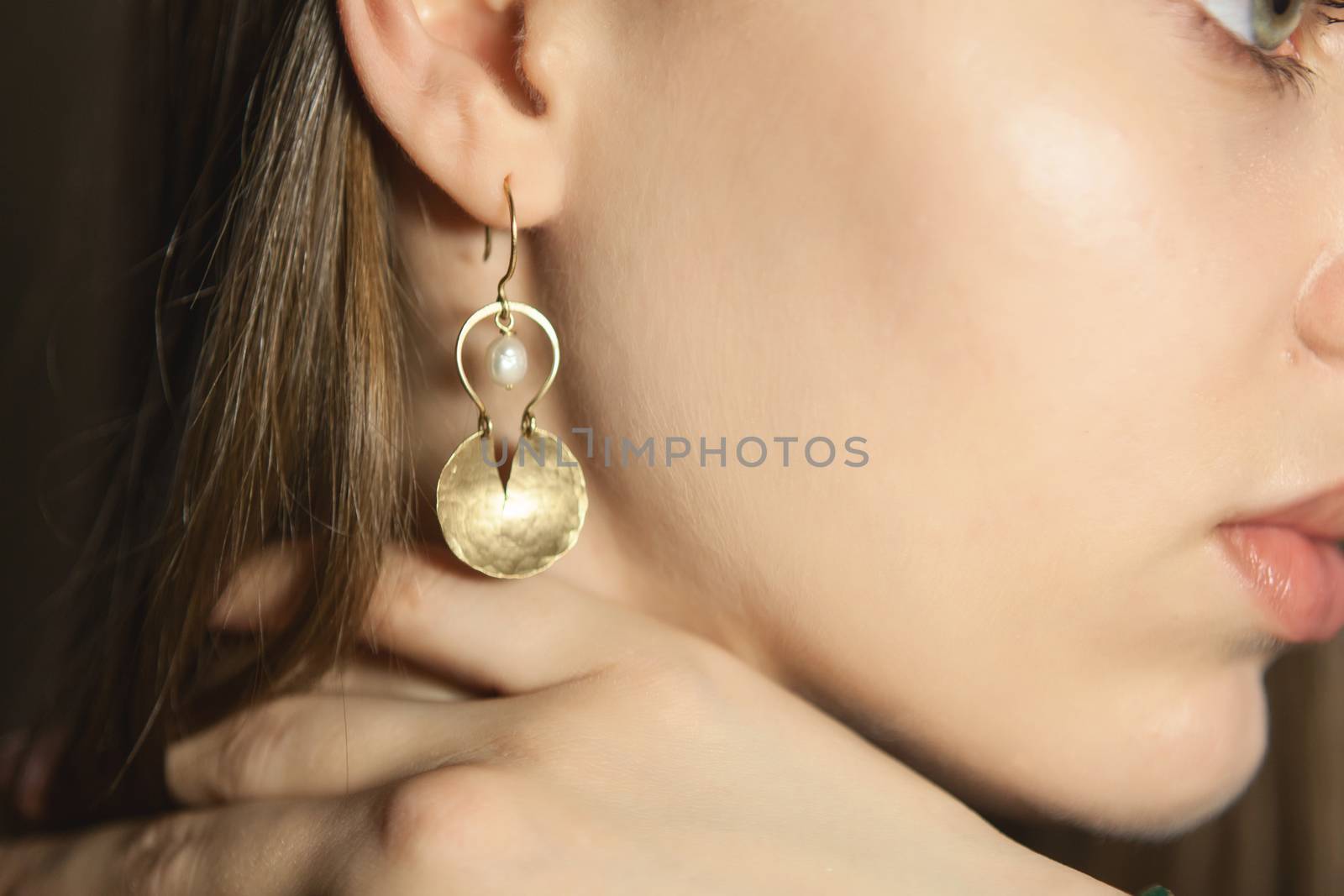 Portrait of beautiful fair young woman with fashion jewelry, one light source