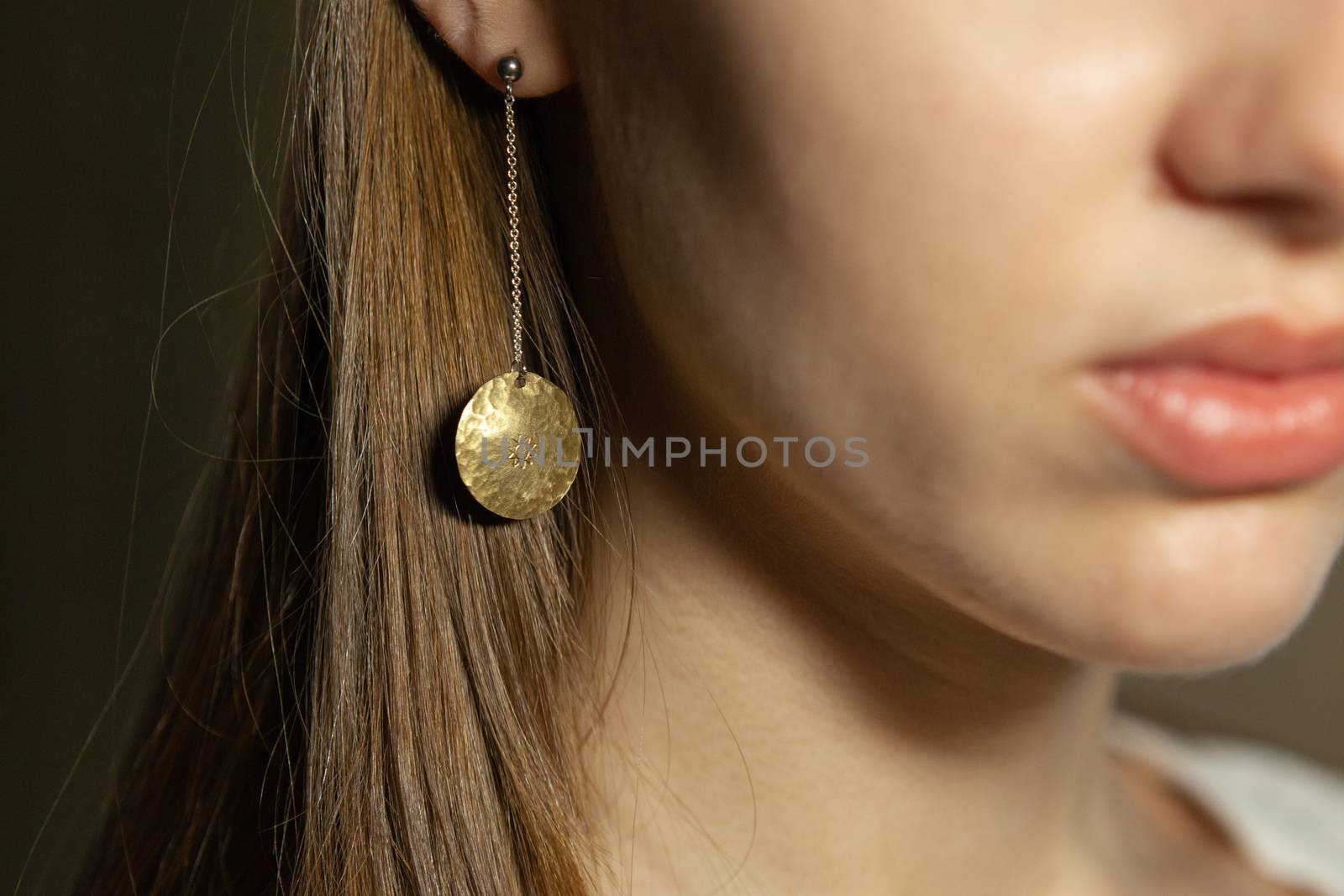 Portrait of beautiful fair young woman with fashion jewelry, one light source