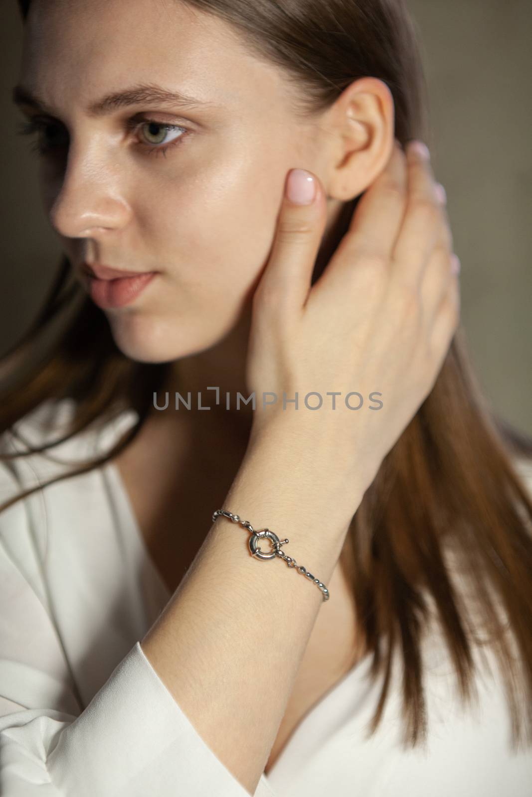 Portrait of beautiful fair young woman with fashion jewelry, one light source