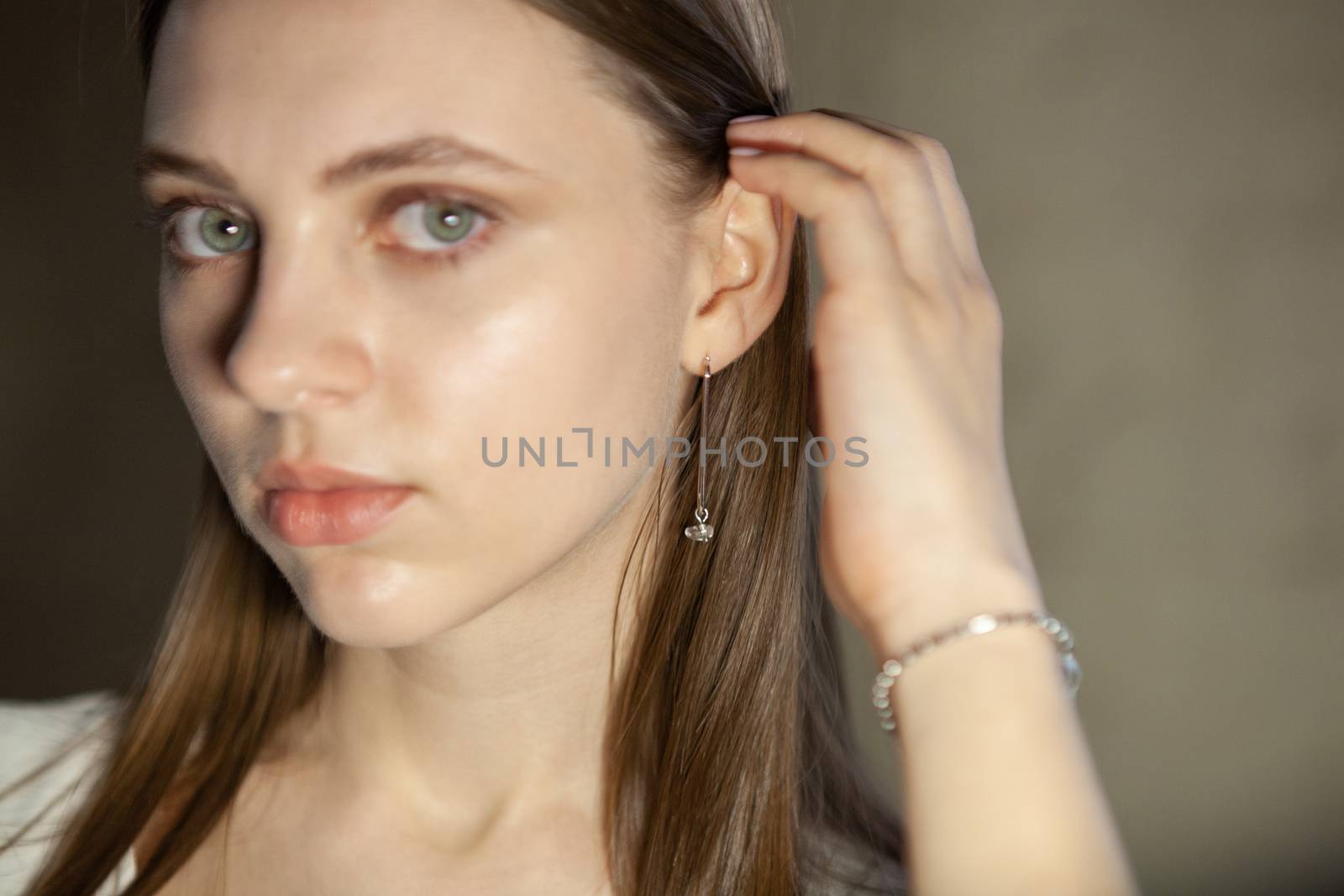 Portrait of beautiful fair young woman with fashion jewelry, one light source