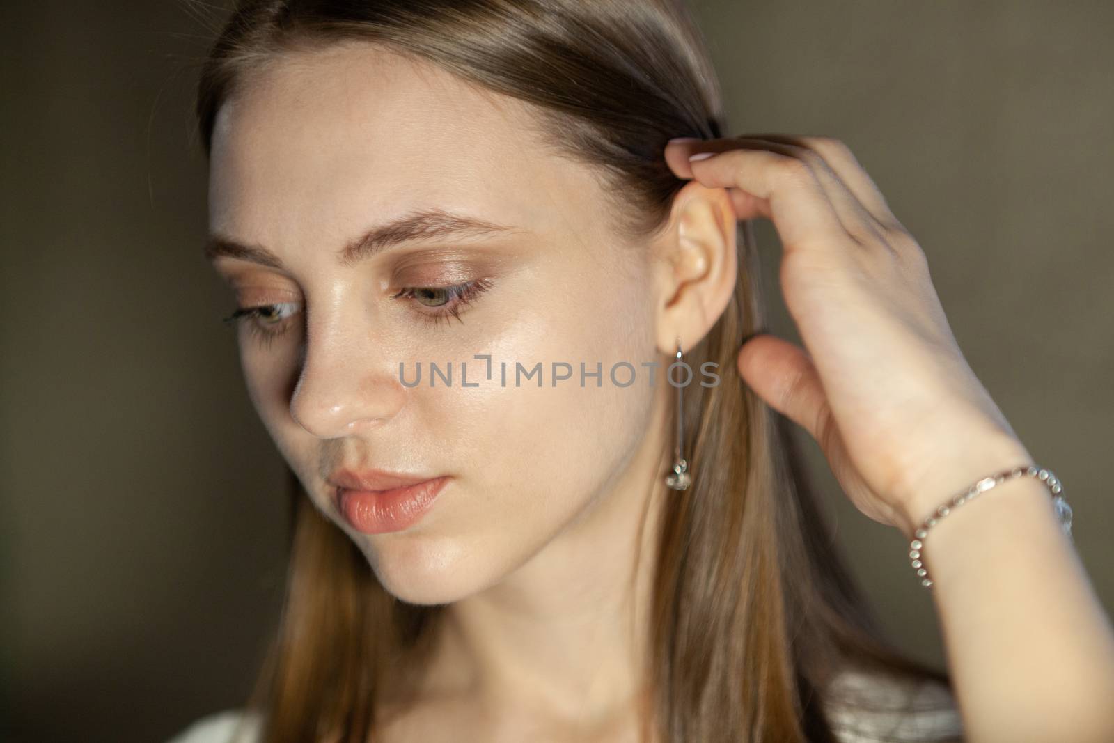 Portrait of beautiful fair young woman with fashion jewelry, one light source