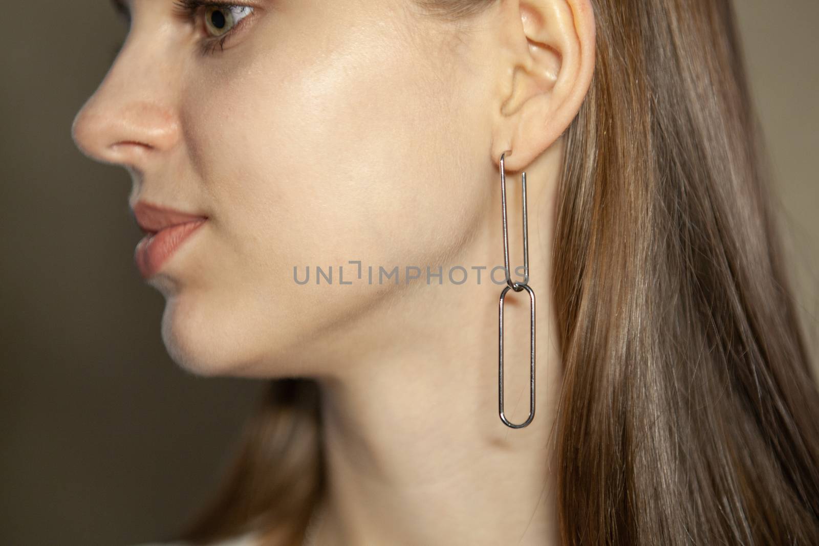 Portrait of beautiful fair young woman with fashion jewelry, one light source