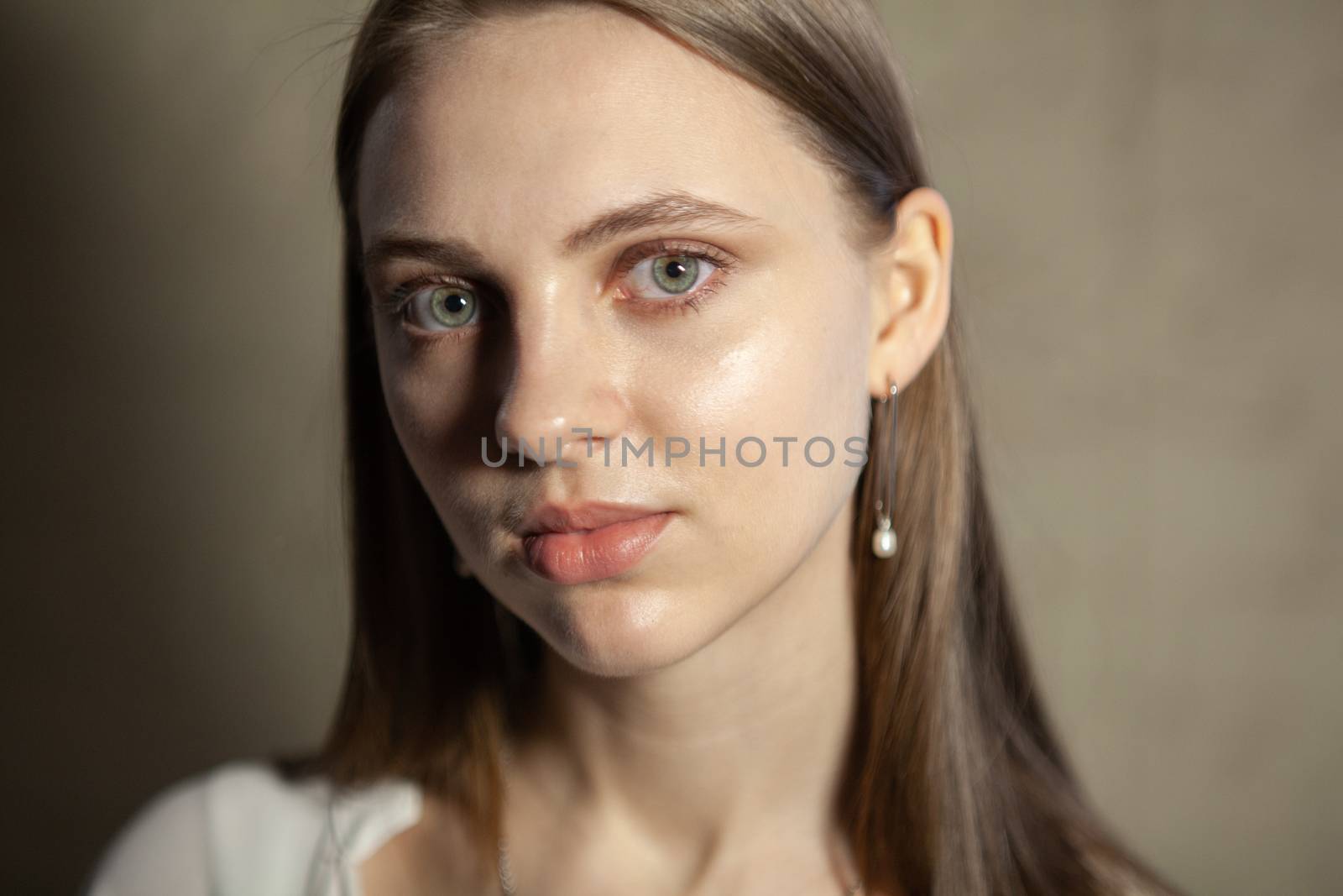 Portrait of beautiful fair young woman with fashion jewelry, one light source