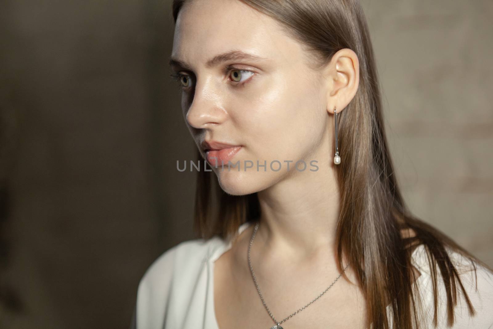 Portrait of beautiful fair young woman with fashion jewelry, one light source