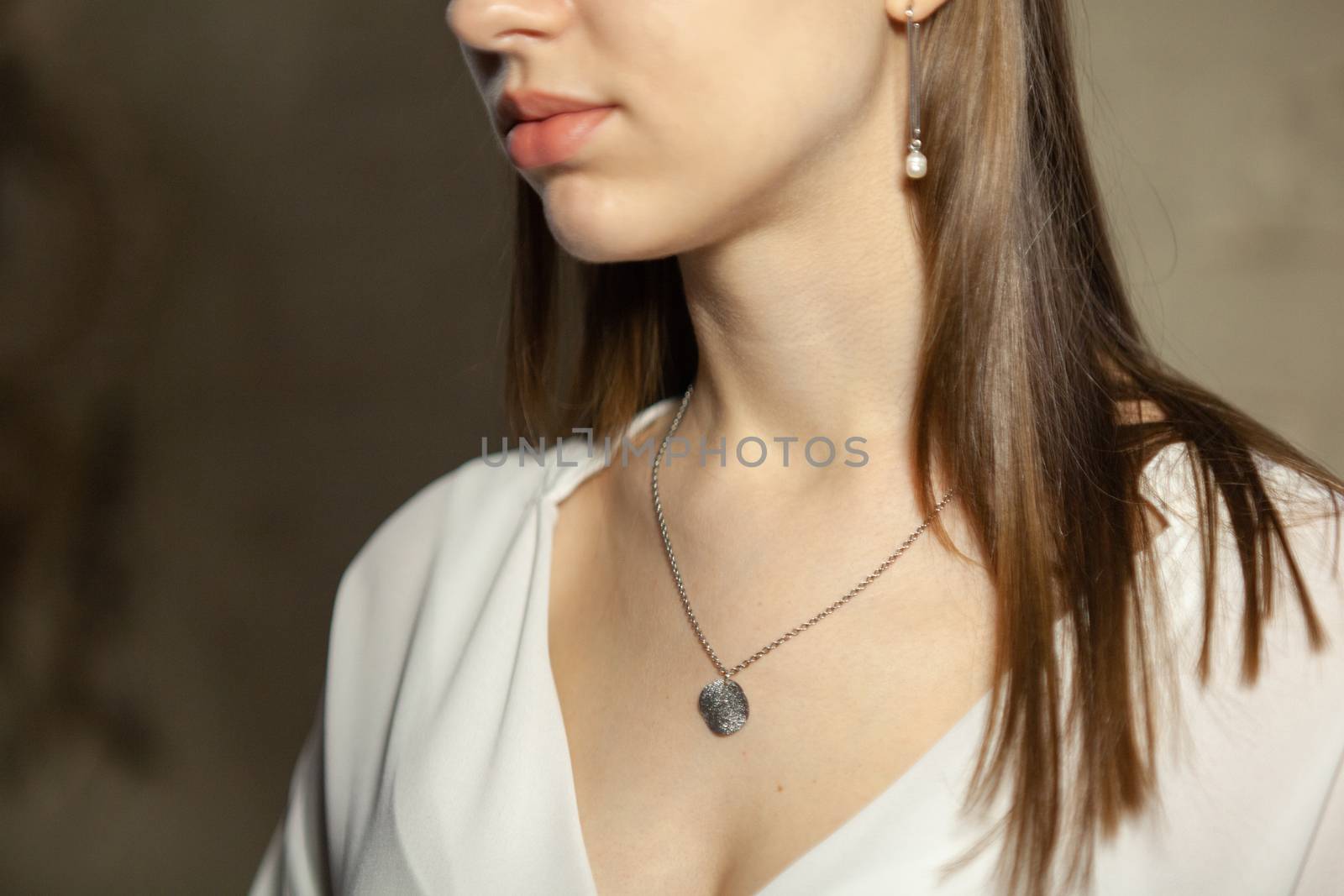 Portrait of beautiful fair young woman with fashion jewelry, one light source