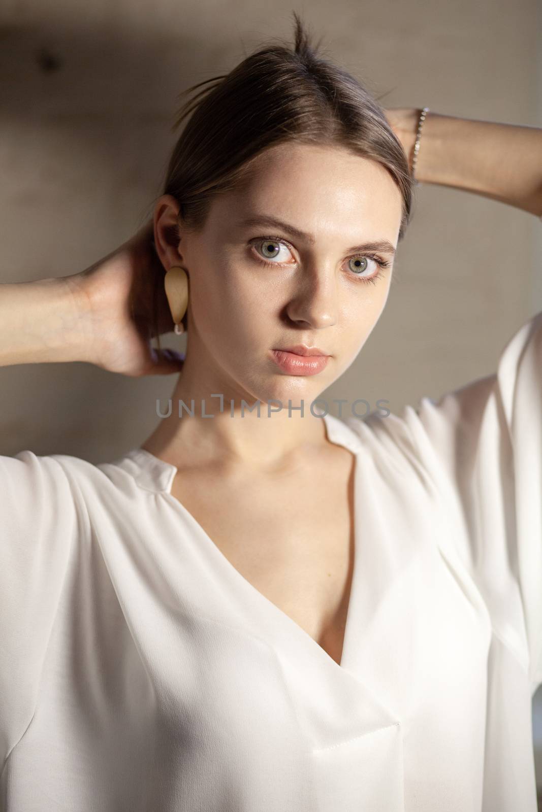 Portrait of beautiful fair young woman with fashion jewelry, one light source