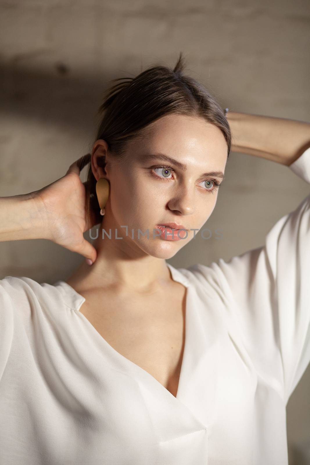 Portrait of beautiful fair young woman with fashion jewelry, one light source